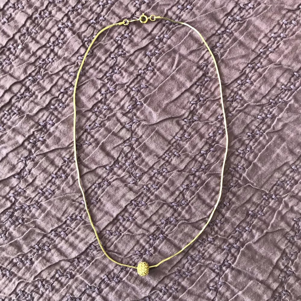Nadri gold-colored necklace with gold mesh ball
